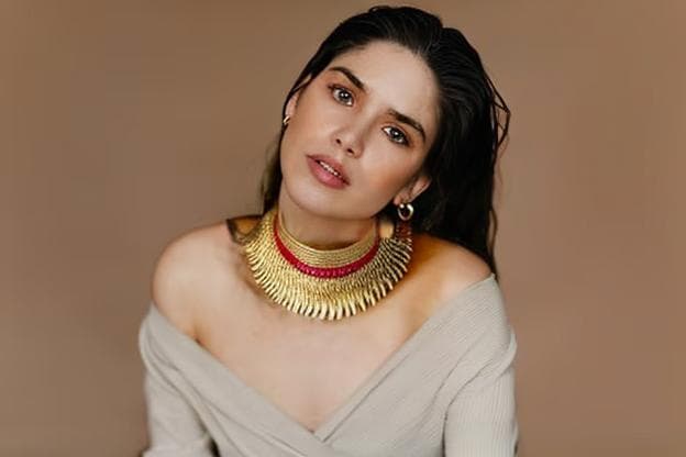 a girl wearing a necklace