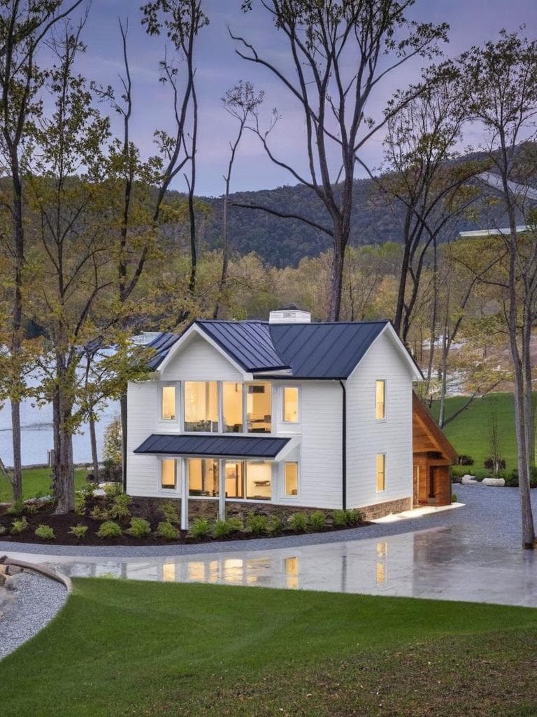 redesign the building exterior in a modern minimalist architectural style, featuring smooth white concrete walls, large glass windows, clean lines, and ambient exterior lighting. replace traditional design elements with sleek, contemporary finishes. keep the perspective and overall structure intact