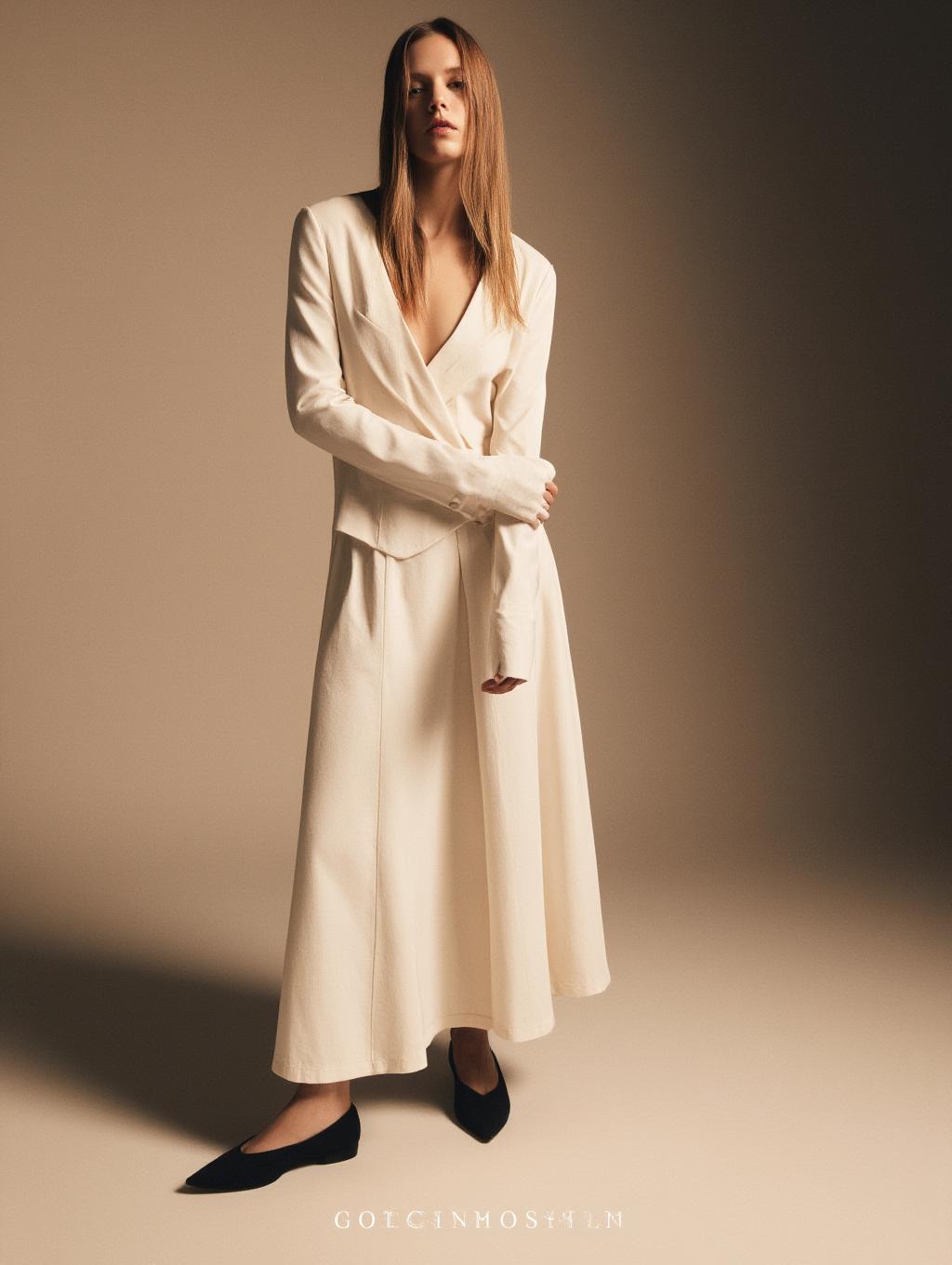  detail, photo, inimalist fashion editorial featuring a model in cream colored, soft textured clothing. the scene is lit with warm, soft lighting that creates gentle shadows, emphasizing the clean lines and fluidity of the outfit. the overall aesthetic is elegant and understated, with muted tones and a calm, serene mood. hyperrealistic, full body, detailed clothing, highly detailed, cinematic lighting, stunningly beautiful, intricate, sharp focus, f/1. 8, 85mm, (centered image composition), (professionally color graded), ((bright soft diffused light)), volumetric fog, trending on instagram, trending on tumblr, HDR 4K, 8K