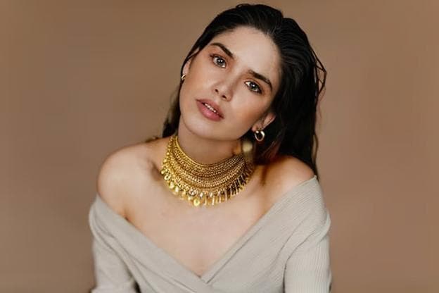 a girl wearing a necklace