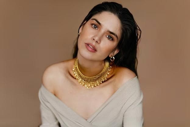 a girl wearing a necklace