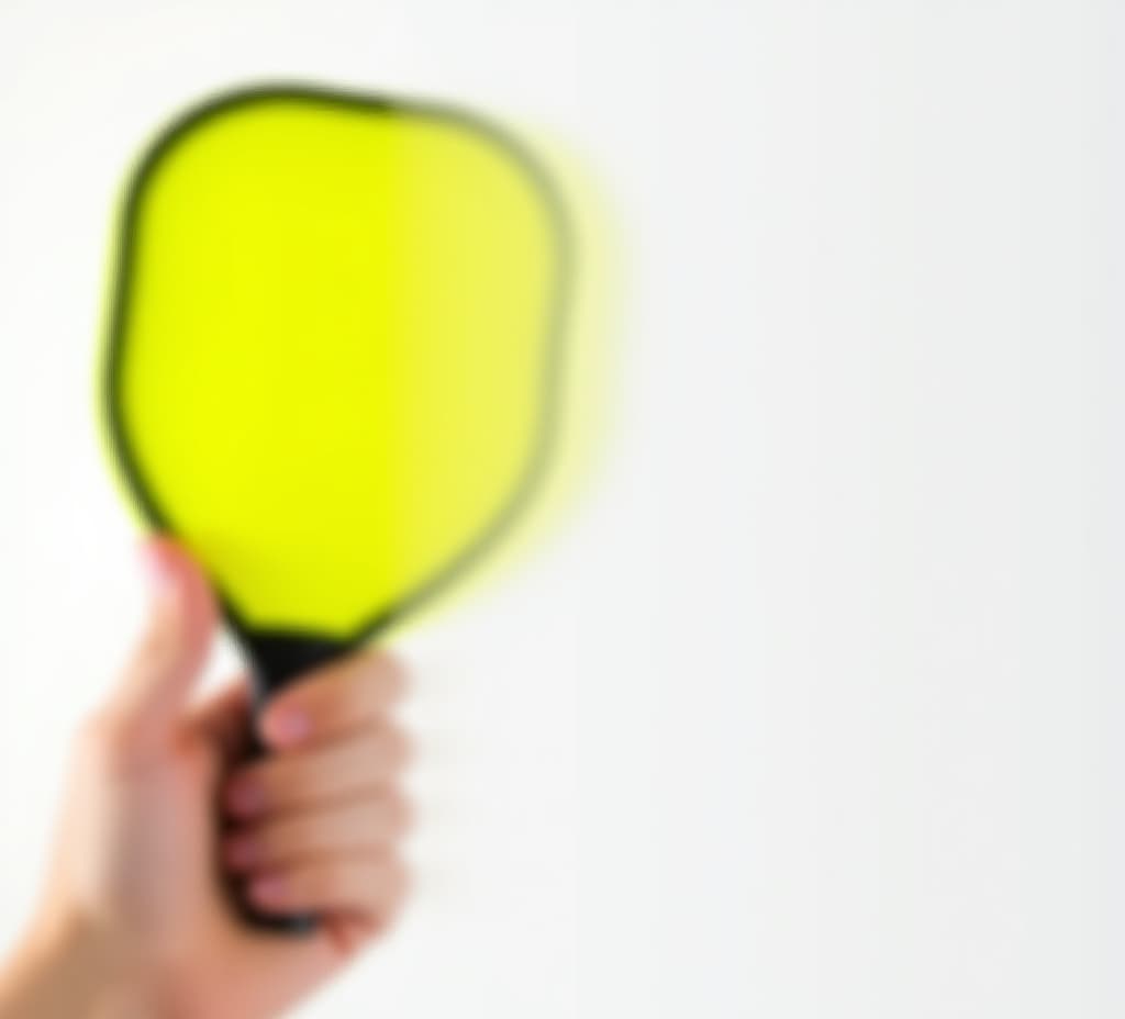  bright neon yellow pickleball held in hand on a white background perfect for a pickleball event banner with copy space image