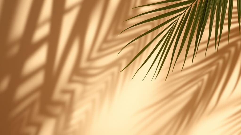  shadows of palm leaves against a soft, warm background.