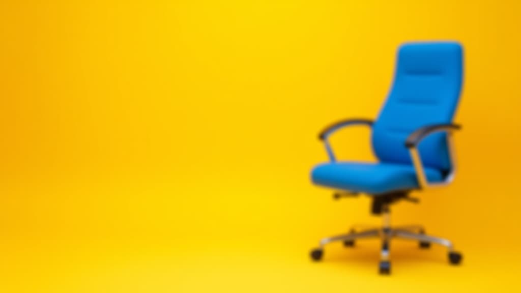  an empty blue office chair against a bright yellow background. job opportunity and recruitment