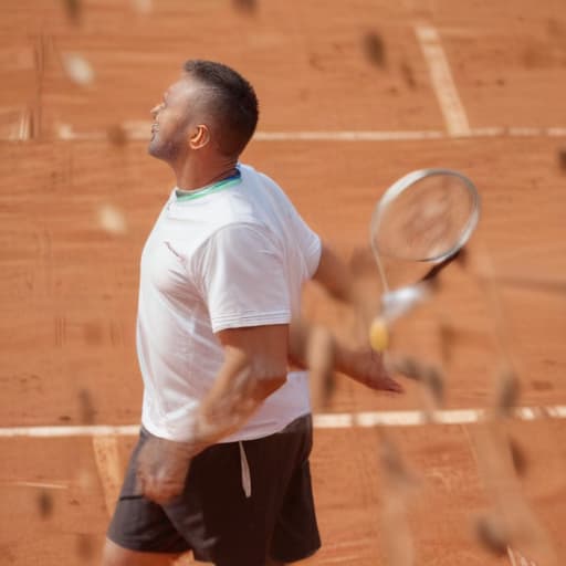 Male 53 years old, 185cm high, 82 kg weight, Brown hairplaying Tennis in Clay court doing a serve