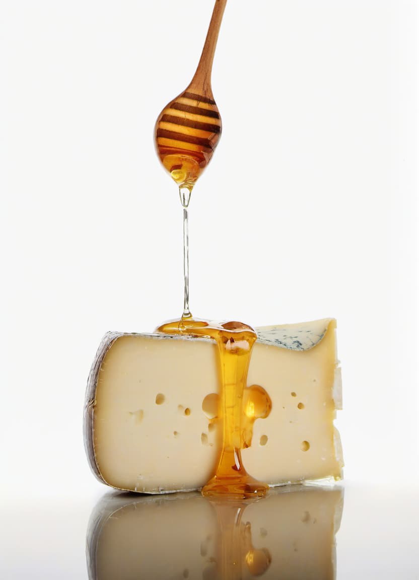  food photography style the cheese is poured with honey beautiful reflection . appetizing, professional, culinary, high resolution, commercial, highly detailed, film photography style