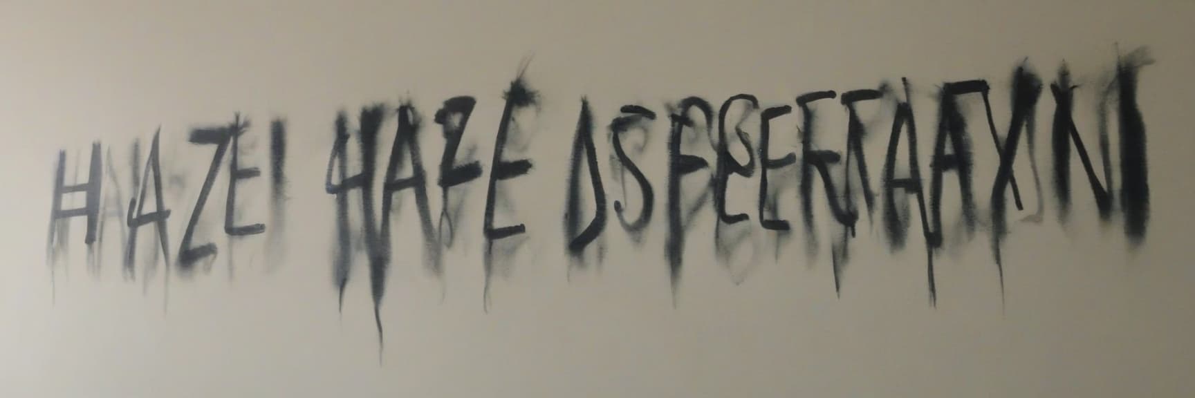  in dark ink on the wall, it says "haze desperation."