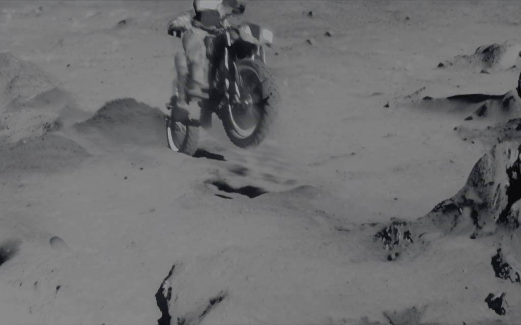 man riding motorcycle on the moon